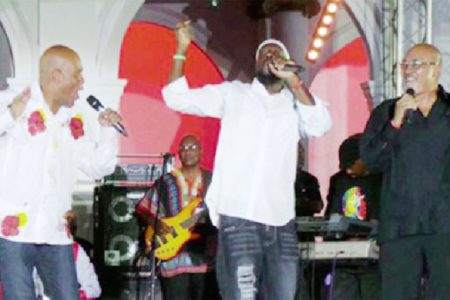 Haitian President Michel Martelly (left), recording artiste Wyclef Jean (centre) and Surinamese President Desi Bouterse sharing a moment at the close of Carifesta X1 in Paramaribo, Suriname. (Caricom photo)