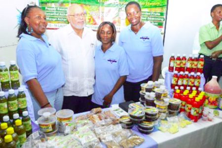 President Donald Ramotar (second from left) with exhibitors at the 9th annual Berbice Expo (GINA photo)