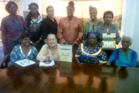 Members of the Women and Gender Equality Commission along with copies of their Annual Report for 2013 and their Five Year Strategic Plan.
