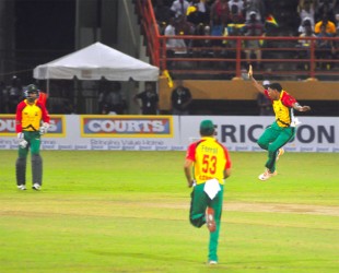 TEAM OVER COUNTRY! Krishmar Santokie celebrates the dismissal of countryman Andre Russell.