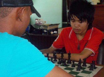 Hai Feng Su is pictured here during his game with Anthony Drayton during the recent Trophy Stall Chess Tournament. Su will represent Guyana at the Inter Guiana Games to be contested locally from August 4-August 8, 2013. The other members of the Guyanese chess team are Davion Mars, Sheriffa Ali and Jessica Clementson. Su, a student of School of the Nations, will captain the team. The IGG chess teams will comprise players from Guyana, Suriname and French Guiana. 