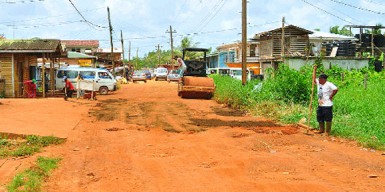 Working to patch the main access road to Kumaka which is pitted with potholes