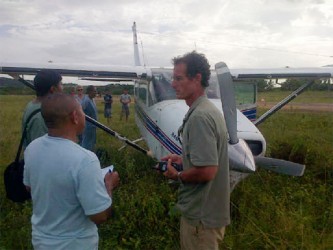 The pilot of the plane (right) speaking to a law enforcement officer shortly after the incident 