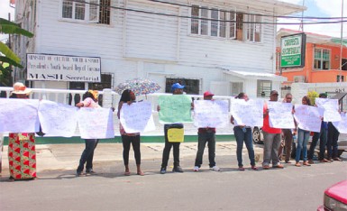 Protestors across the street from the Georgetown Magistrates’ Court building on Middle Street, demonstrating against the sentencing of four policemen found guilty of assaulting businessman Nizam Khan (Photo by Arian Browne) 