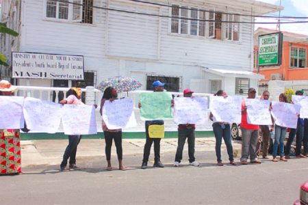 Protestors across the street from the Georgetown Magistrates’ Court building on Middle Street, demonstrating against the sentencing of four policemen found guilty of assaulting businessman Nizam Khan (Photo by Arian Browne)
