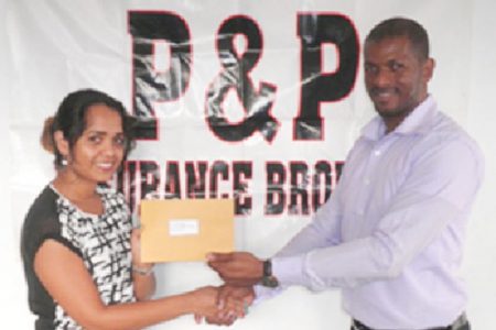 Accounts Executive of P & P Insurance Brokers Limited Samantha Singh hands over the cheque to GTTA president Godfrey Munroe.