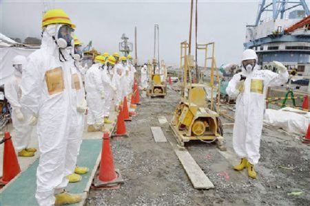 Members of a Fukushima prefecture panel, which monitors the safe decommissioning of the nuclear plant, inspect the construction site of the shore barrier, which is meant to stop radioactive water from leaking into the sea, near the No.1 and No.2 reactor building of the tsunami-crippled Fukushima Daiichi nuclear power plant in Fukushima, in this photo released by Kyodo August 6, 2013. REUTERS/Kyodo
