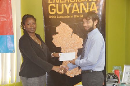 NAWF President Vanessa Dickenson receives the sponsorship cheque from Lucozade Brand Manager Sunesh Maikoo.