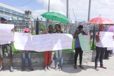 Relatives of the four policemen who were sentenced to 18 months each last week staging a protest on the corner of Brickdam and Avenue of the Republic 