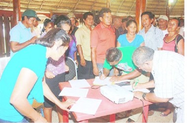 A large group of people rushed to sign the petition which calls for the Amerindian Act of 2006 to be amended. (Arian Browne photo)