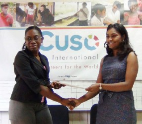 Coordinator of WAD Clonel Samuels-Boston and CUSO country representative Tara Persaud hold the agreement after yesterday’s signing 