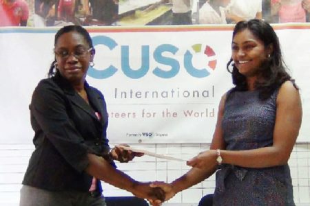 Coordinator of WAD Clonel Samuels-Boston and CUSO country representative Tara Persaud hold the agreement after yesterday’s signing 