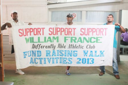 William France along with Dennis Berne and John Antoo with the banner for today’s ‘William France Fitness Walk’.