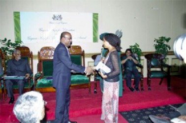 Haitian writer Myriam Chancy shakes then President Bharrat Jagdeo’s hand after receiving the Guyana Prize for Literature Caribbean Award in the Fiction category for her book ‘The Loneliness of Angels.’ Guyana Prize for Literature Management Committee yesterday announced that there will be no regional prize conferred at the upcoming awards ceremony owing to a lack of funding. (Stabroek News file photo)