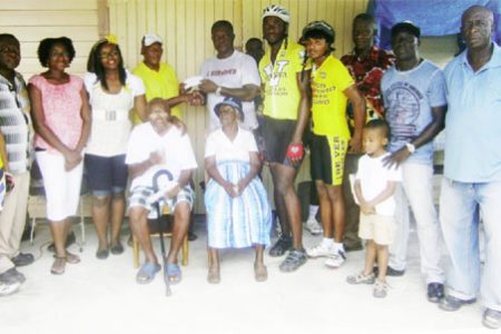 Roberts receives his reward from Rawle Felix while 96-year-old Grenville Felix and 94-year-old Rachel Michael among other family members savour the moment.
 