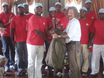 One of the successful coaches Jamal Hinckson receives his equipment from Guyana Baseball League Chairman Dominic O’Sullivan.