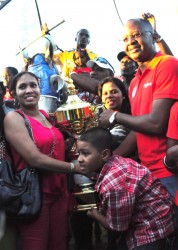  Digicel’s CEO, Gregory Dean, presenting the Digicel Horse Race Classic champion’s trophy to owners of Score’s Even after the thoroughbred galloped to win the feature ‘B’ and Lower seven furlongs event yesterday. (Orlando Charles photo) 