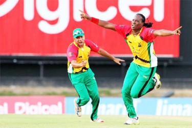 Guyana’s Steven Jacobs  celebrates his dismissal of star batsman Kieron Pollard (not in picture) as skipper Ramnaresh Sarwan rushes to join  in the celebration. (Photo courtesy of CPLT20 website) 
