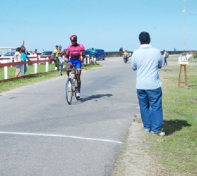 Easy Does It! National rider, Orville Hinds crossing the line without a rival in sight in yesterday’s feature 30-lap event of the Bryden and Fernandes 11-race Classic at the Sea Wall Bandstand. 