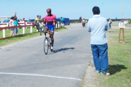 Easy Does It! National rider, Orville Hinds crossing the line without a rival in sight in yesterday’s feature 30-lap event of the Bryden and Fernandes 11-race Classic at the Sea Wall Bandstand.
