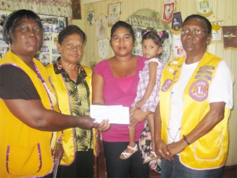 NA Lions Club President, Georgina Hoosley (left) presenting the cheque to Melissa Chase in the presence of other Lions members   
