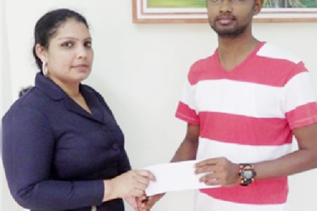 Satish Gobin receives his cheque from Bibi Alli
