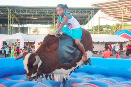 No fear: Riding the bull at the Jamzone kids zone at the National Park on Monday.
