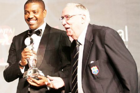 I wasn’t expecting anything like that! Jackie Hendriks seen here receiving the award from WICB President Dave Cameron.