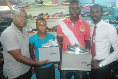 Champion athletes from the recent Boyce & Jefford Track and Field Classic IV, Stephan James and Alita Moore (centre) receive their Asics footwear as part of their prizes, compliments of Giftland OfficeMax. Giftland’s, Compton Babb and Co-coordinator of the meet, Edison Jefford share the moment.