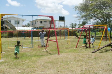 Children making full use of the playground equipment donated by the GAIL Foundation to the New Amsterdam Special Needs School in Berbice
