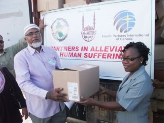 GIRO Chief Executive Officer Shazaad Khan presents a quantity of medical supplies to Norma Semple, Principal Tutor of the School of Nursing and board member of the Georgetown Hospital (GPH). 