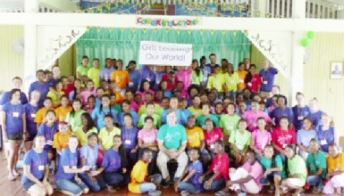  US Ambassador Brent Hardt (centre) sits among participants and volunteers at Camp GLOW. 