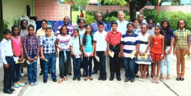 Recipients of Banks DIH bursary awards hold their certificates as company representatives, including Co-Managing Director/Marketing Director George McDonald (second from left, back row) look on. 