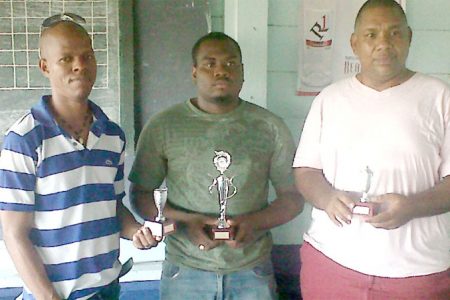 Wayne Cave along with Maurice Munro and Roberts Williams after the tournament concluded last Sunday at the Mateenoes Sports Club, Thomas Land.
