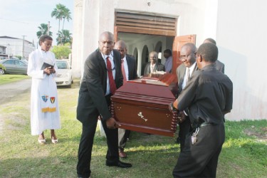 Last rites for Harold Davis: The coffin of Harold Davis being borne out of the Trinity Methodist Church on High and Leopold streets yesterday. (Arian Browne photo)