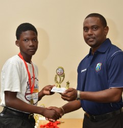 Ashmead Nedd receives his trophy for Most Promising Player from Guyana from Head Coach Dwain Gill - WICB Media photo