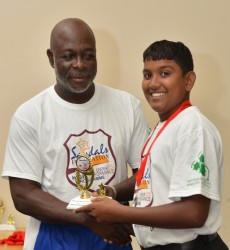 Guyana captain Bashkar Yadram receives the Most Disciplined Team award from Camp Coordinator Austin Richards Sr - WICB Media photo 