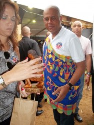 Haitian President Michel Martelly contemplating a piece of sculpture bought from a Guyanese sculptor last week at Carifesta XI in Suriname