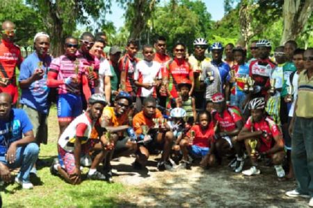 National cyclist Alanzo Greaves (middle) poses with other prize winners after the event at the National Park yesterday. (Orlando Charles photo)