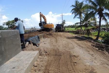 The sea defence work on Wakenaam. The road damage is evident in the background. (Ministry of Public Works photo)