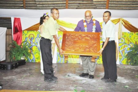 President Donald Ramotar (centre) is presented with a token at the Amerindian Heritage Month 2013 launching (GINA photo)