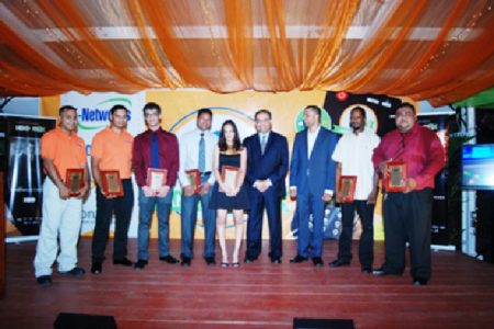 Managing Director of E-Networks, Vishok Persaud (third from right) shares the stage with honoured staff members. (GINA photo)