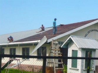 Repairs being done to the roof of the Shieldstown Nursery yesterday