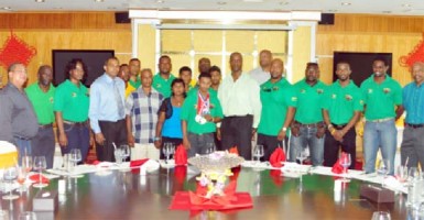 POWER MOVE! Guyana’s youngest ever World Champion, Gumendra Shewdas (with medals) poses with members of his family, executive members of the Guyana Amateur Power lifting, medalists at July’s Caribbean and Pan American Championships as well as Minister of Sport, Dr. Frank Anthony and Permanent Secretary of the Ministry during yesterday’s luncheon at the New Thriving Restaurant. (Orlando Charles photo)