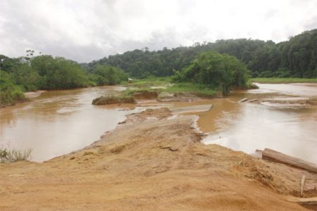 The polluted Konawaruk River with the banks dug up. 