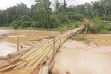 Bridge across the Konawaruk:  The crude, wooden bridge used by miners to get over the Konawaruk River close to Mousie Landing, Region Eight.  