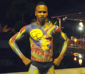 Jamain Victor in body paint of the Caricom and Carifesta logos at a fashion show 