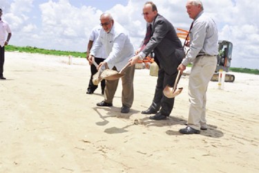 President Donald Ramotar (left)  joins Chief Executive Officer of Qualfon, Mike Marrow  (centre) and Site Director Mark Boyer to turn the sod for the Qualfon multi-building campus at Providence. (GINA photo)
