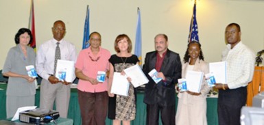 Minister of Health, Dr. Bheri Ramsaran (third from right) , representatives from PAHO, CDC and staff of the Ministry display the National Plan for Infection Prevention and Control 2012-2016 (GINA photo)