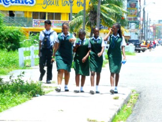 There is a hint of purposefulness in the strides of these young ladies, presumably renewing old acquaintances during a school break on Thursday. Their male colleague appears to be several steps behind.